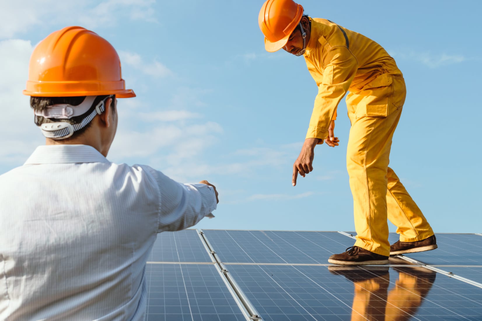Energy & sustainability — engineers on a solar installation
